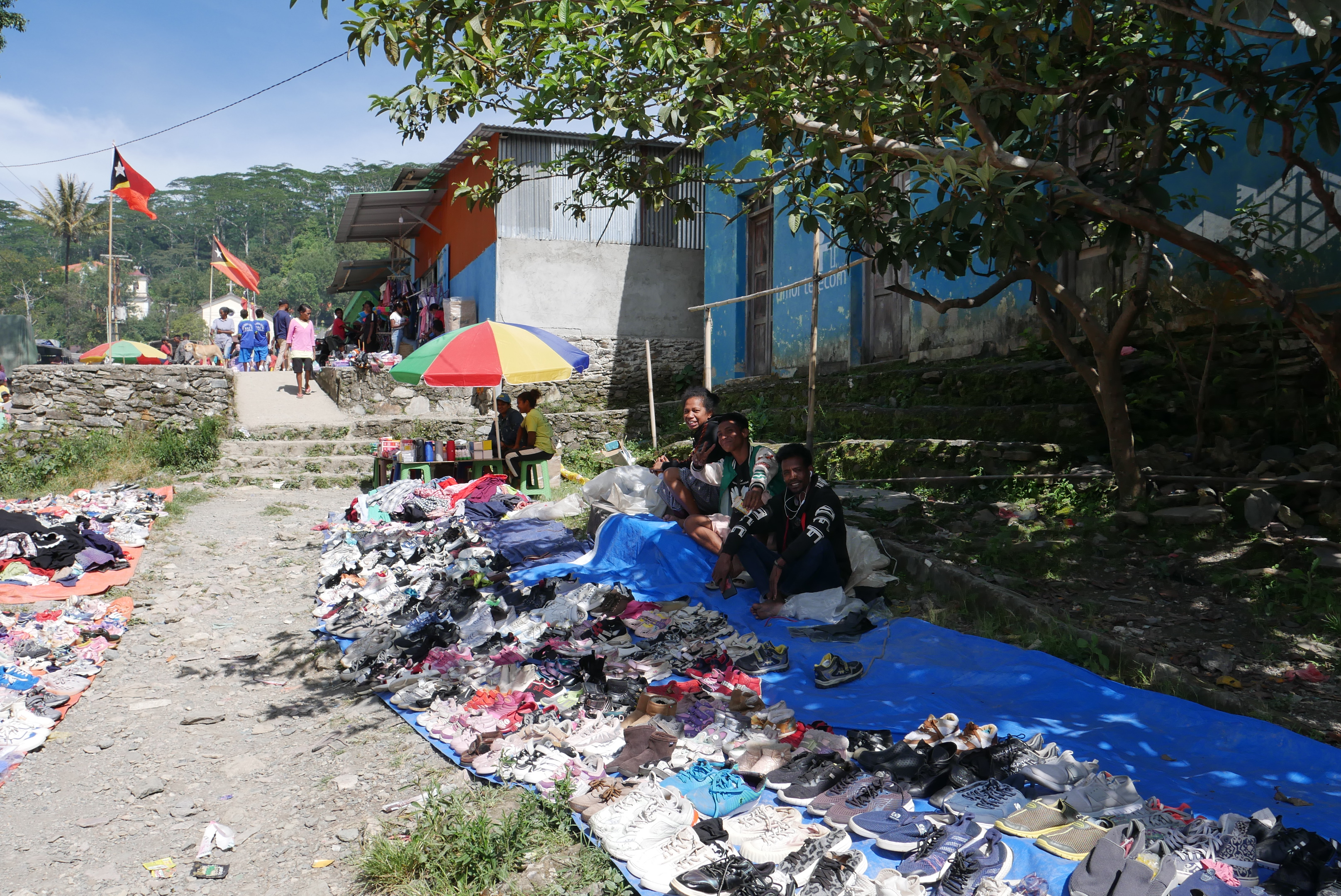Market vendors sitting in shade